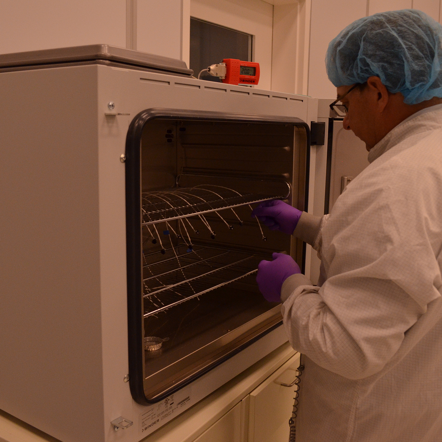 Rob Woodward (ASU) looking at the LTES Thermistors after their oven cure.